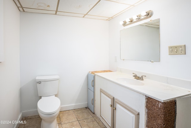 bathroom featuring tile patterned flooring, vanity, and toilet