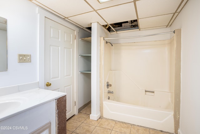 bathroom featuring tile patterned flooring, vanity, a paneled ceiling, and  shower combination