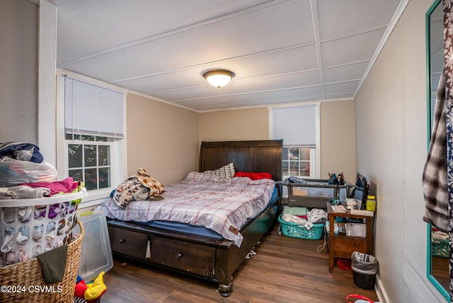 bedroom with dark wood-type flooring