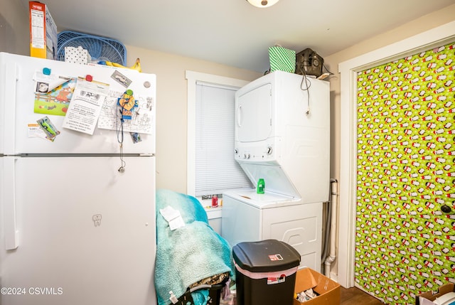 clothes washing area with stacked washer and clothes dryer