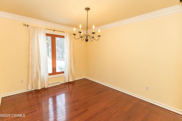 empty room featuring wood-type flooring, ornamental molding, and a chandelier