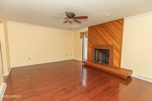 unfurnished living room featuring ceiling fan, hardwood / wood-style floors, ornamental molding, and a tiled fireplace