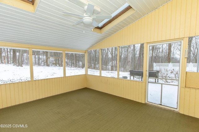 unfurnished sunroom featuring ceiling fan and vaulted ceiling