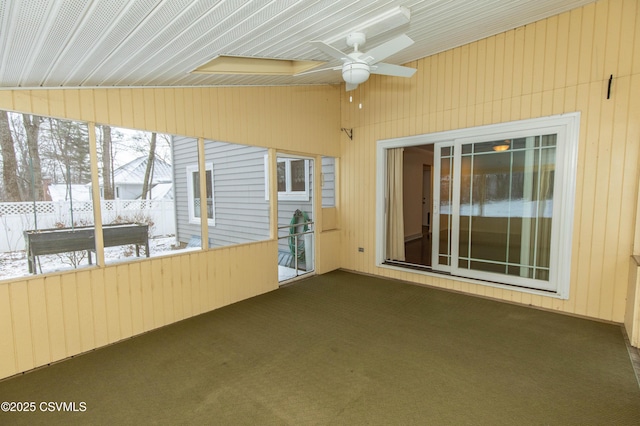 unfurnished sunroom featuring ceiling fan and lofted ceiling