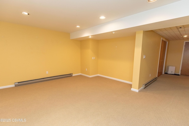 spare room with carpet and a baseboard radiator