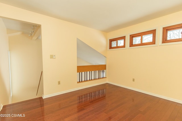 unfurnished room with plenty of natural light and hardwood / wood-style floors