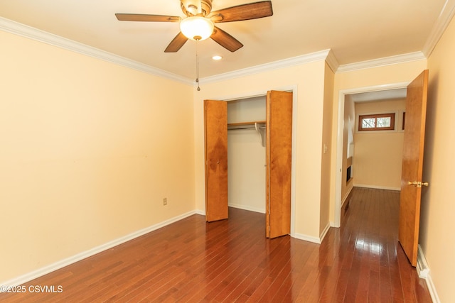 unfurnished bedroom featuring ceiling fan, dark wood-type flooring, a closet, and crown molding