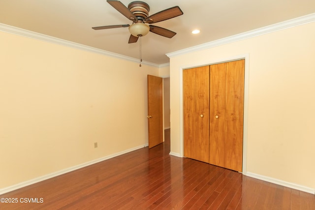 unfurnished bedroom featuring ceiling fan, a closet, dark hardwood / wood-style flooring, and ornamental molding