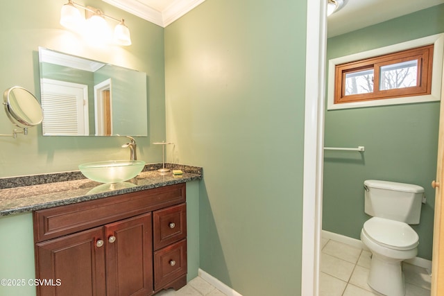 bathroom featuring toilet, vanity, tile patterned floors, and ornamental molding