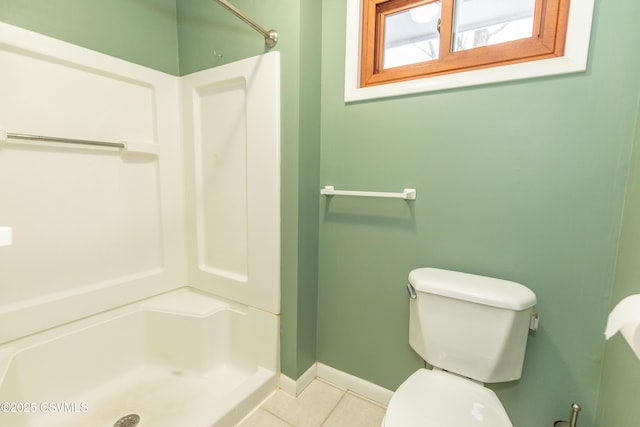 bathroom featuring toilet, tile patterned flooring, and walk in shower