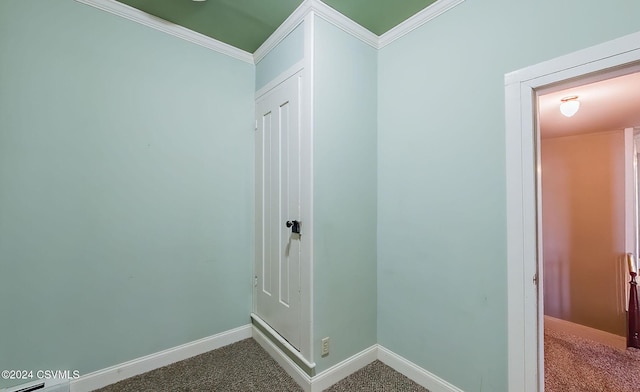 hallway featuring crown molding and carpet