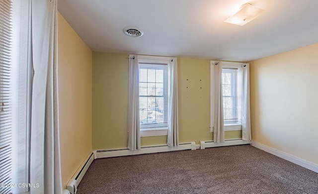 entryway with baseboard heating, carpet, and a healthy amount of sunlight