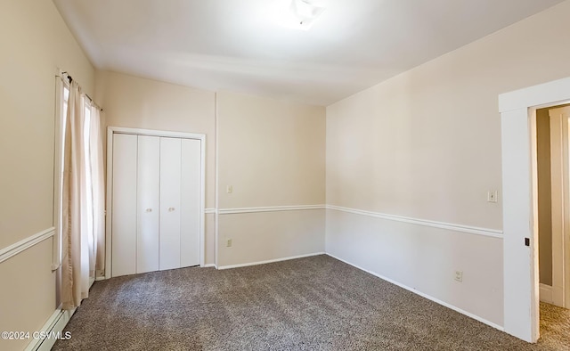 unfurnished bedroom featuring a closet, carpet, and a baseboard radiator