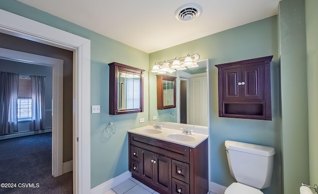 bathroom with tile patterned floors, vanity, and toilet