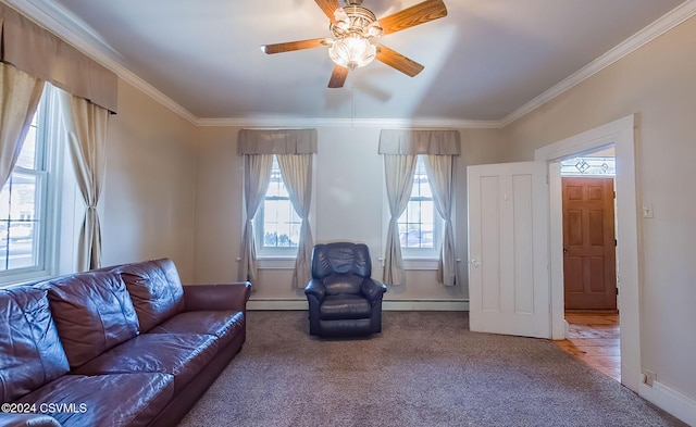 carpeted living room featuring a baseboard heating unit, ceiling fan, and crown molding