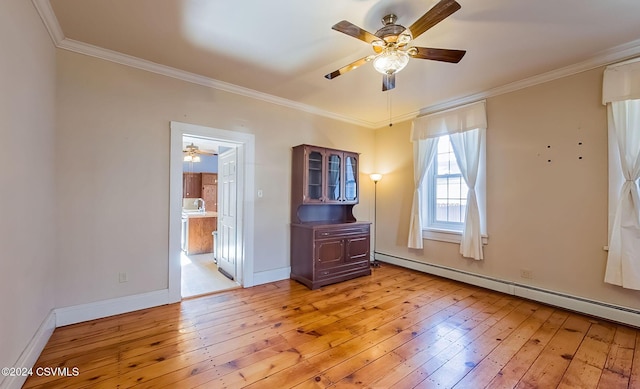 spare room with crown molding, light hardwood / wood-style floors, and a baseboard radiator