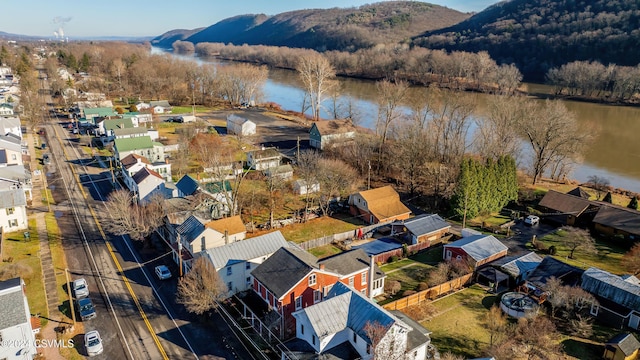 drone / aerial view featuring a water and mountain view