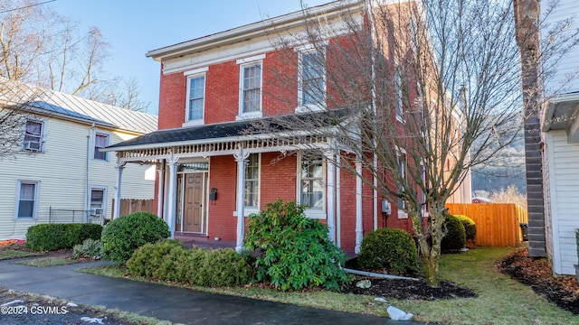 italianate-style house featuring a porch