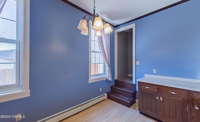 interior space with baseboard heating, light hardwood / wood-style floors, a notable chandelier, and ornamental molding