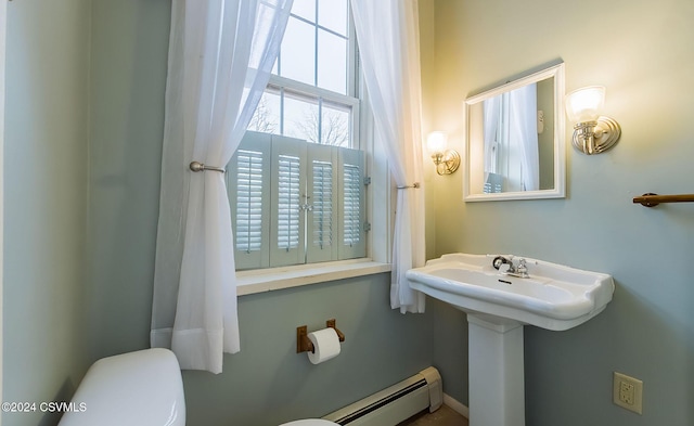 bathroom with toilet and a baseboard heating unit