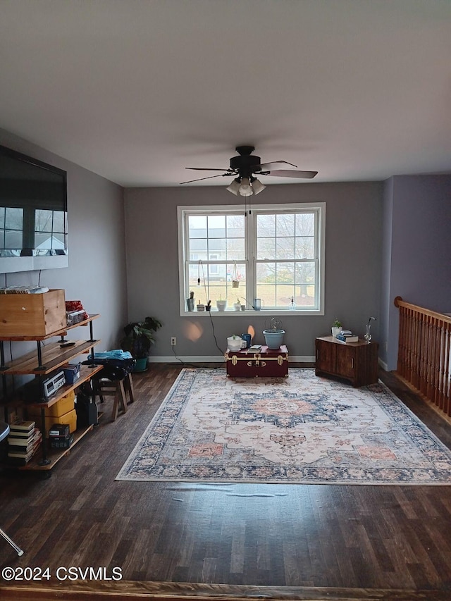 living area featuring hardwood / wood-style flooring and ceiling fan