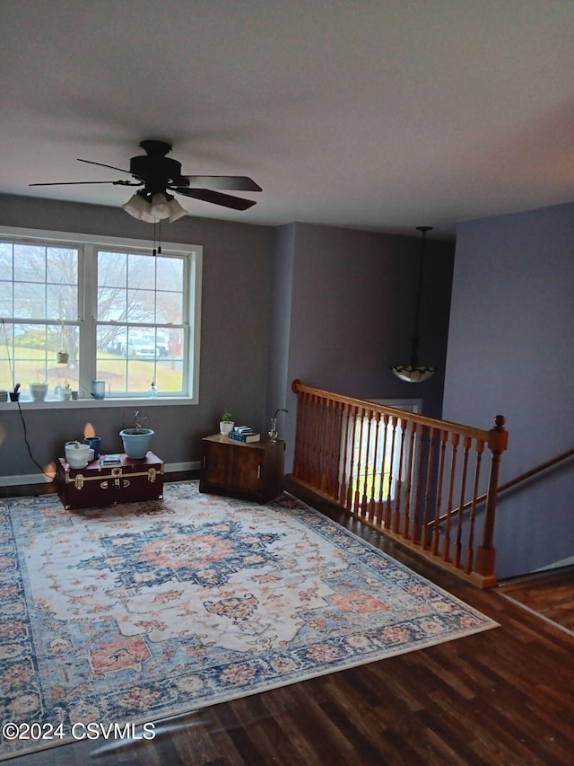 sitting room with wood-type flooring and ceiling fan