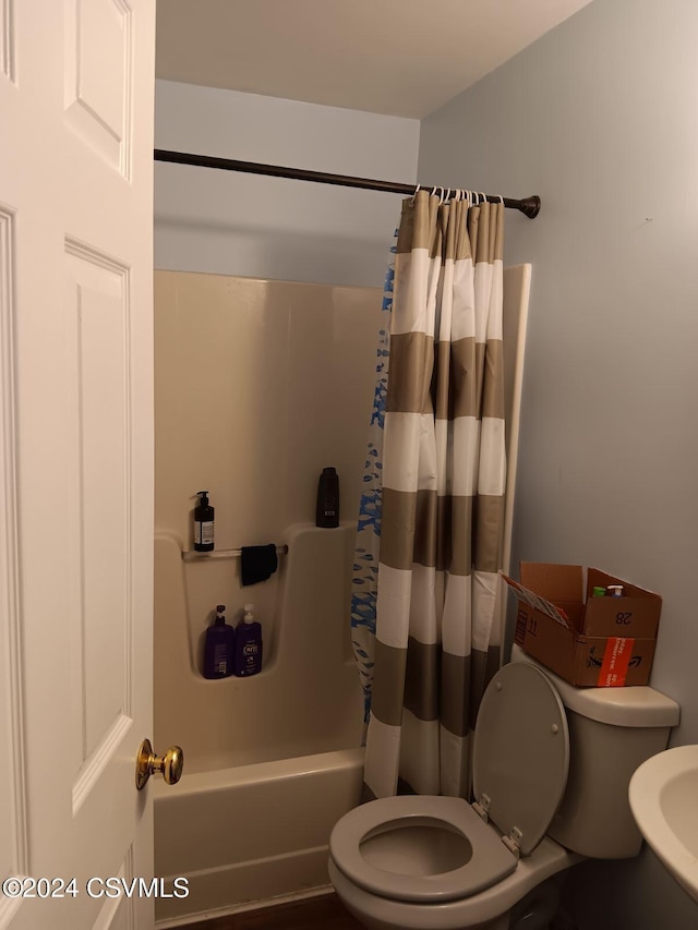 bathroom with shower / bath combo and toilet