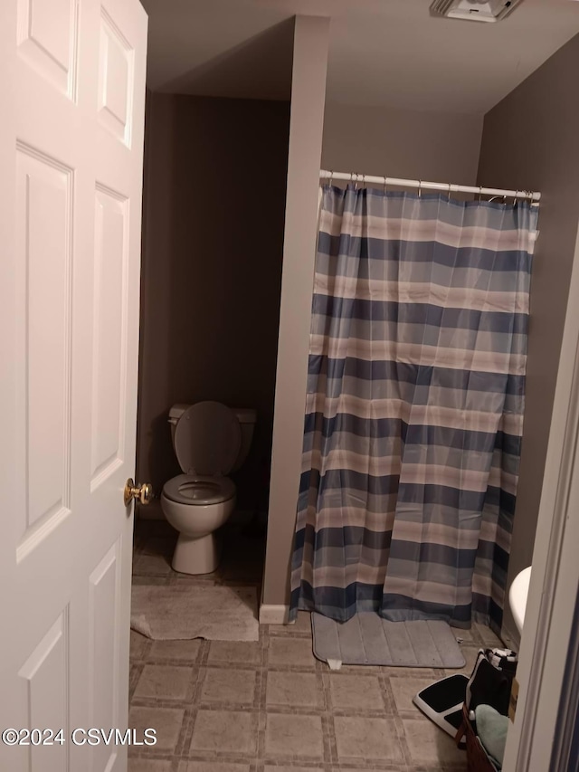 bathroom with walk in shower and toilet