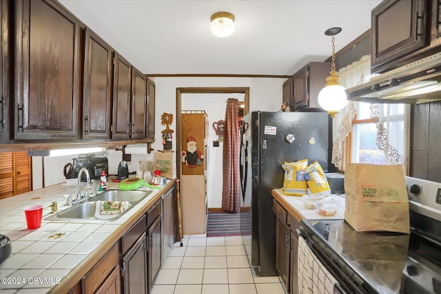 kitchen featuring sink, hanging light fixtures, ventilation hood, tile countertops, and light tile patterned floors