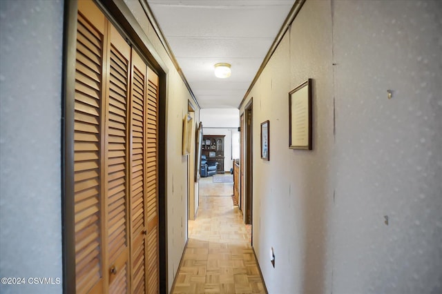 hallway featuring crown molding and light parquet floors