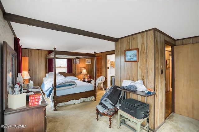 carpeted bedroom featuring beam ceiling and wooden walls