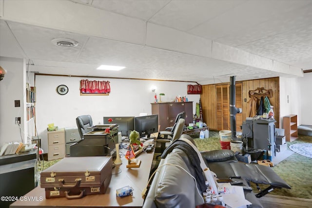 interior space with a paneled ceiling and wood walls