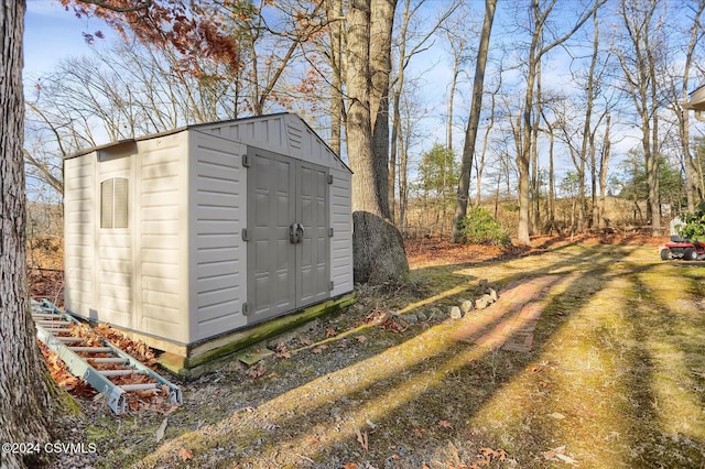 view of outbuilding with a lawn