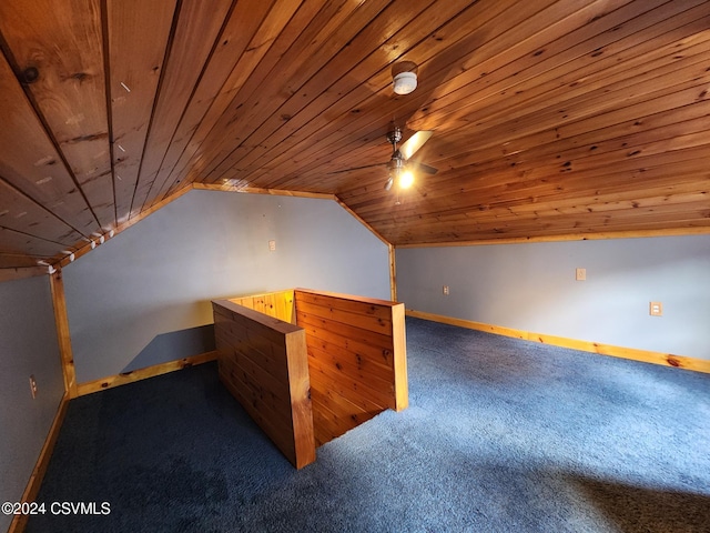 additional living space with ceiling fan, wood ceiling, lofted ceiling, and dark colored carpet