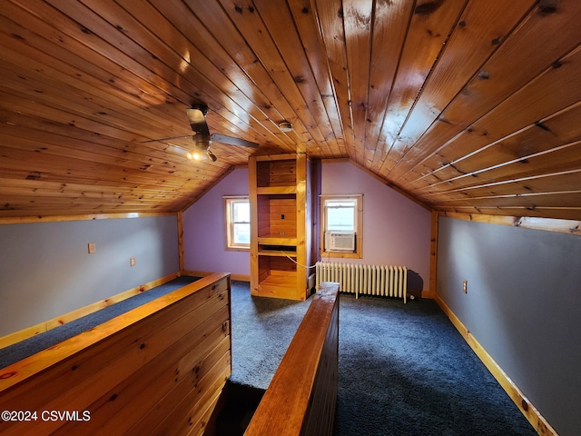 additional living space with radiator, dark colored carpet, cooling unit, vaulted ceiling, and wood ceiling