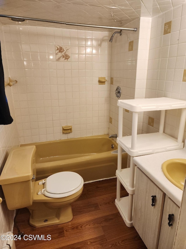 full bathroom featuring vanity, toilet, tiled shower / bath, and hardwood / wood-style flooring