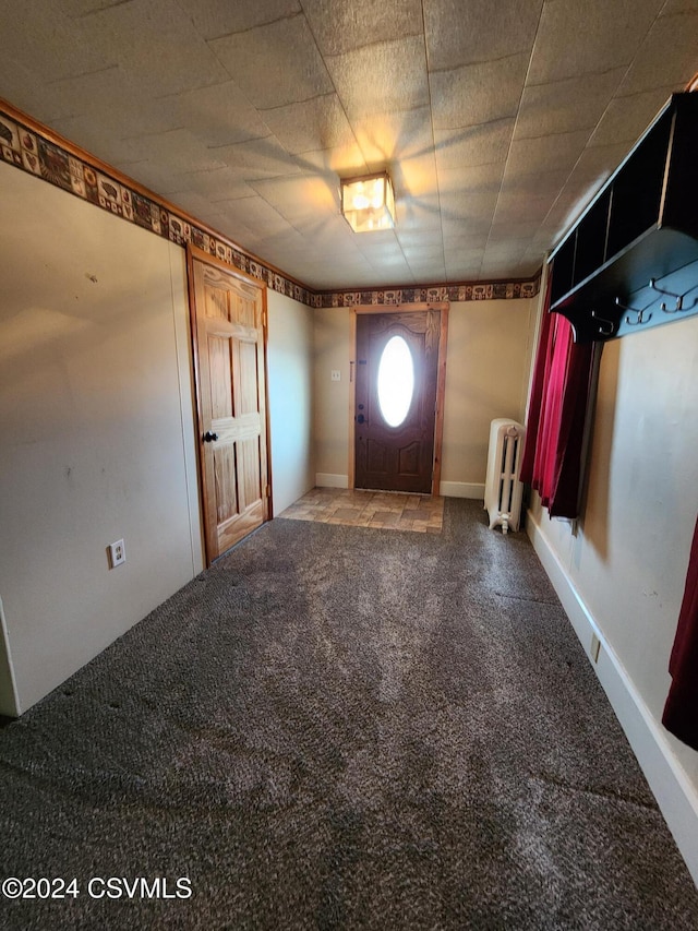 foyer with carpet flooring and radiator heating unit