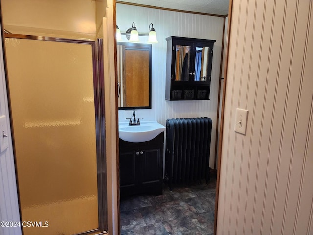 bathroom featuring radiator, vanity, and an enclosed shower