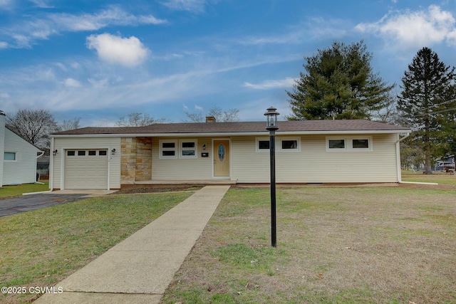 ranch-style home with a garage and a front lawn