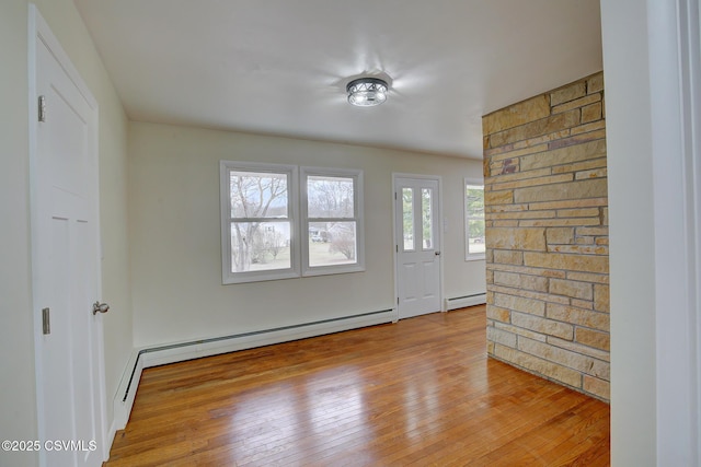 entrance foyer with light hardwood / wood-style floors and a baseboard heating unit