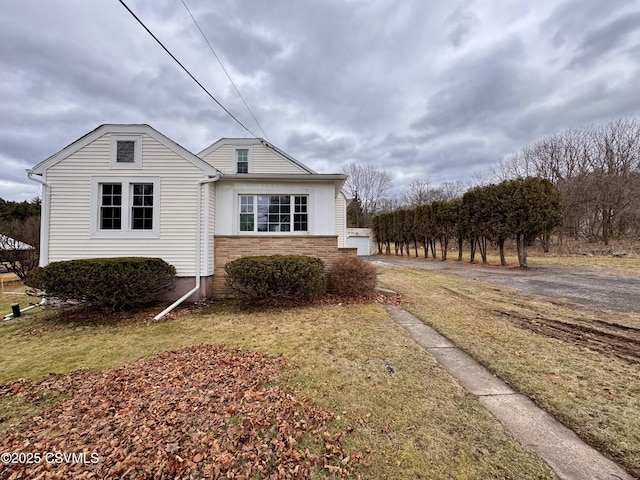 view of side of home with a yard