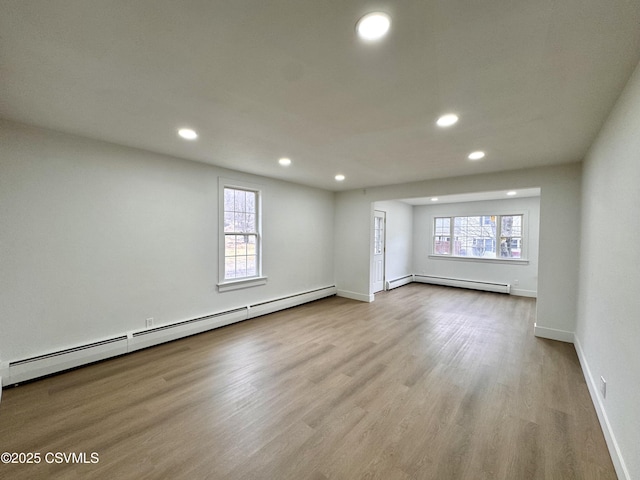 spare room with light hardwood / wood-style floors and a baseboard heating unit