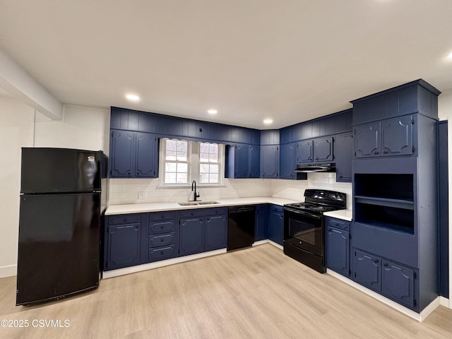 kitchen featuring decorative backsplash, light wood-type flooring, blue cabinets, sink, and black appliances