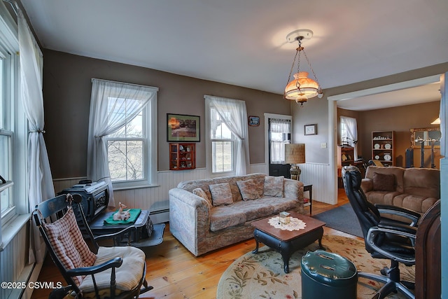 living room with light hardwood / wood-style flooring and a baseboard radiator