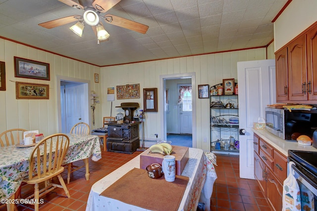 tiled dining room featuring ceiling fan and ornamental molding