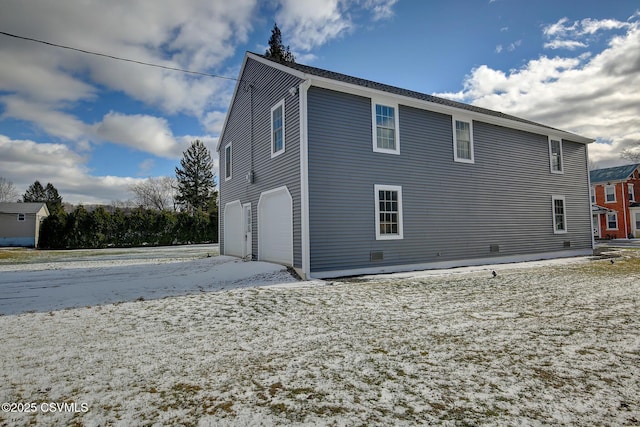 back of property with a garage