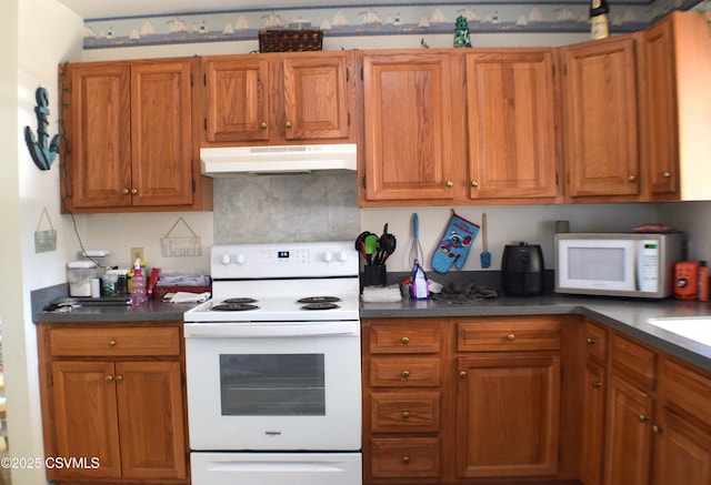 kitchen featuring backsplash and white appliances