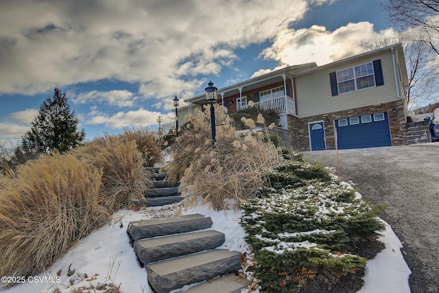 view of front of house featuring a garage and a balcony