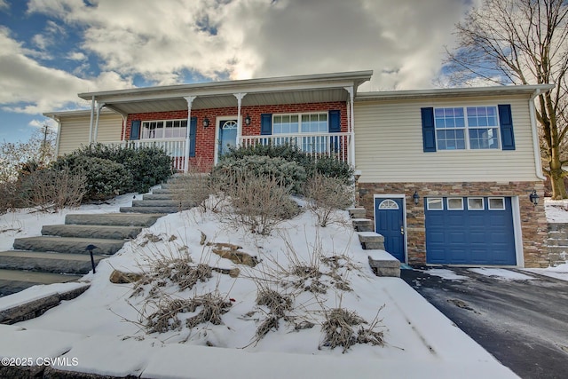 view of front of home with covered porch and a garage