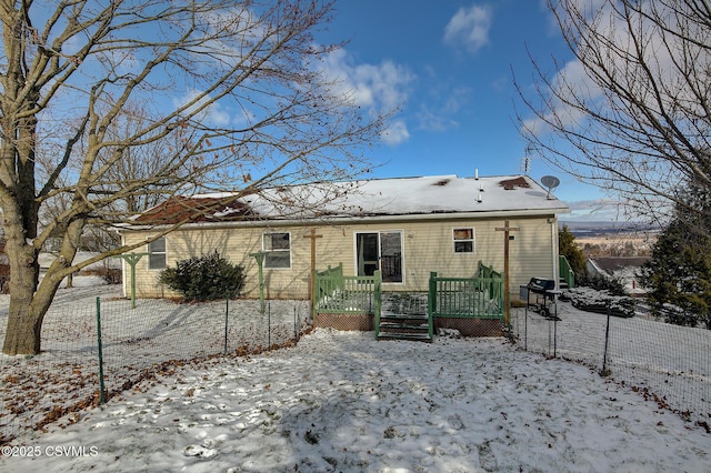 snow covered property featuring a deck